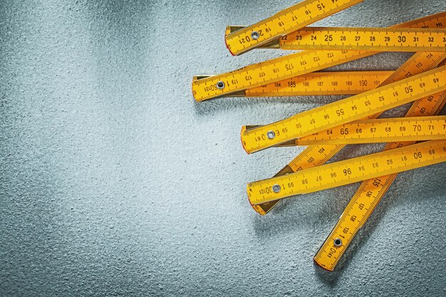 Wooden meter on concrete background copy space construction concept.