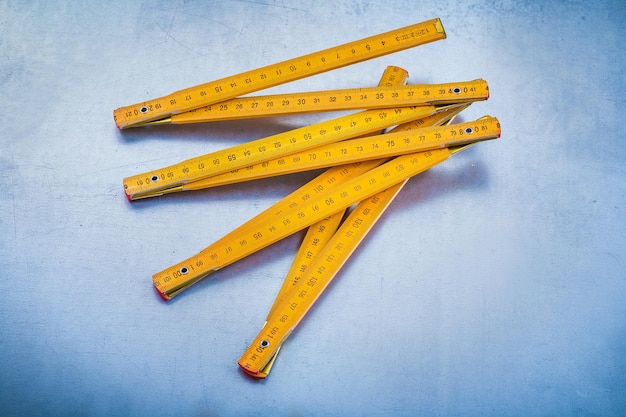 Wooden meter on metallic background vertical view construction concept