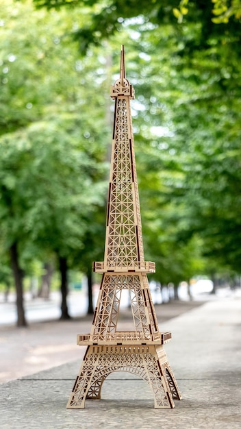 A wooden model of the Eiffel Tower in Paris against the background of nature