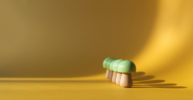 Wooden mushrooms on a creamcolored background Copy space