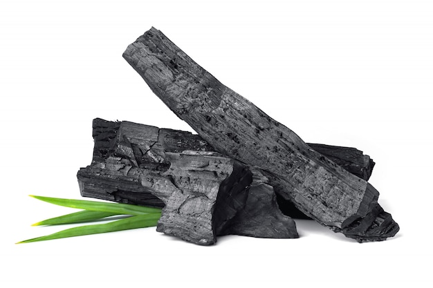 Wooden natural charcoal with pandan leaf isolated on white surface