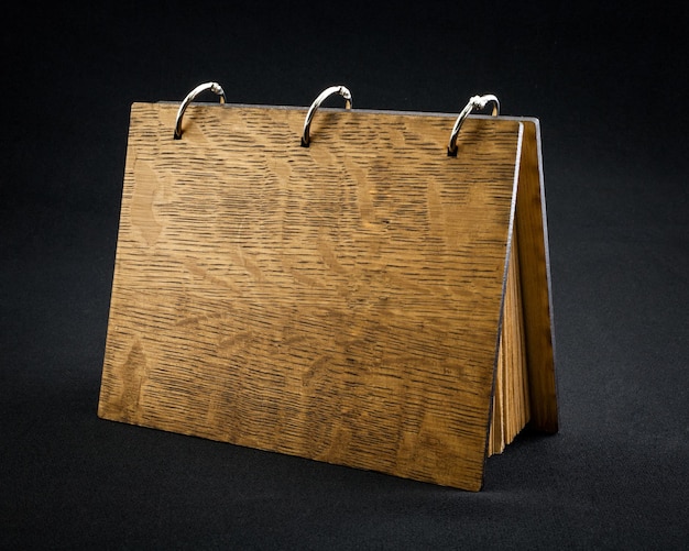 Wooden notebook on a dark background