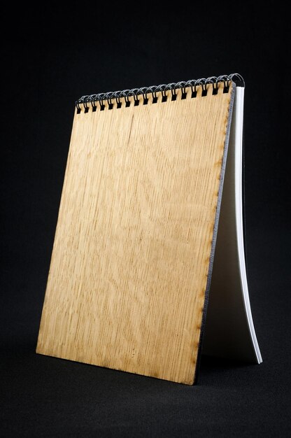 Wooden notebook on a dark background