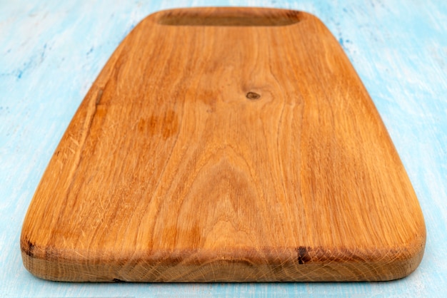 Wooden oak cutting board. Kitchenware. Copy space.