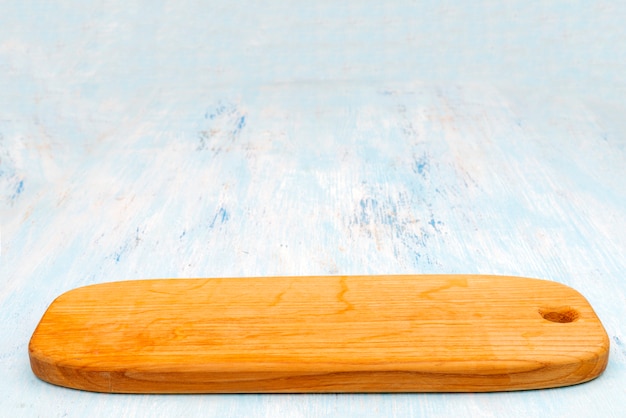 Wooden oak cutting board. Kitchenware. Copy space.