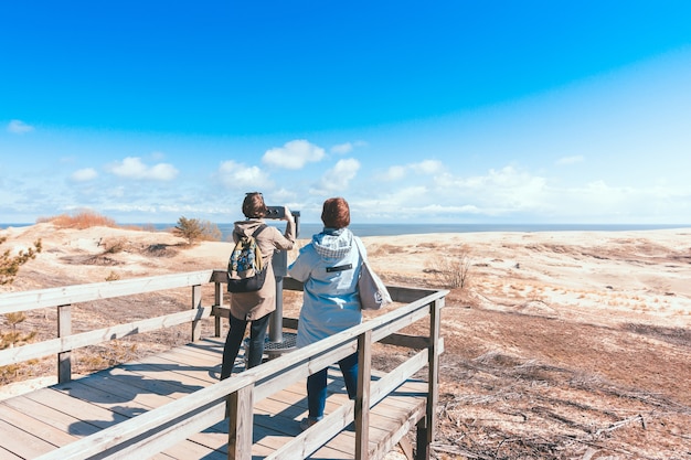 Wooden observation deck with stationary observation metal binoculars