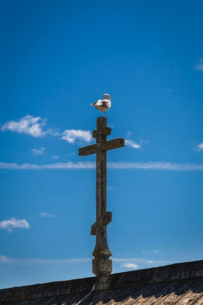 Wooden Orthodox cross on the roof of the building against the blue sky Kizhi Island Karelia Russia