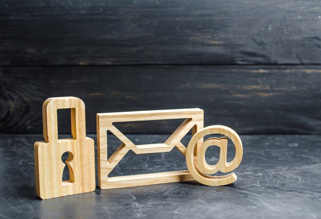 Wooden padlock stands next to the email envelope. 