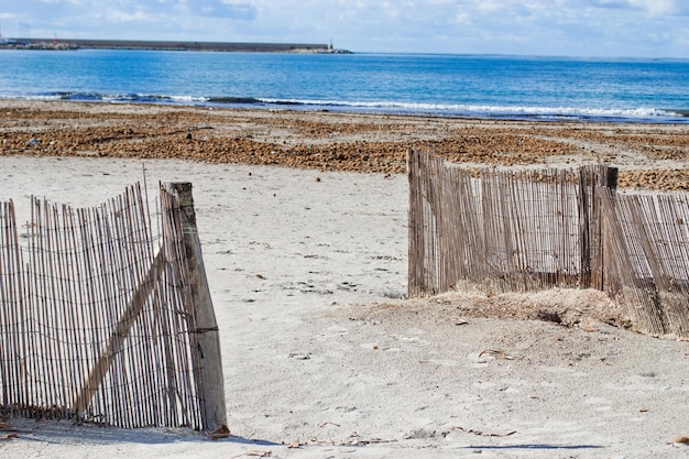 Wooden palisades by the beach in Alghero Italy