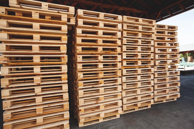 The wooden pallets stacked on top of each other in several rows in a warehouse