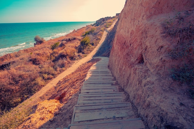 Wooden path for descending to the sea from a steep shore