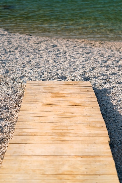 A wooden path leads to the sea