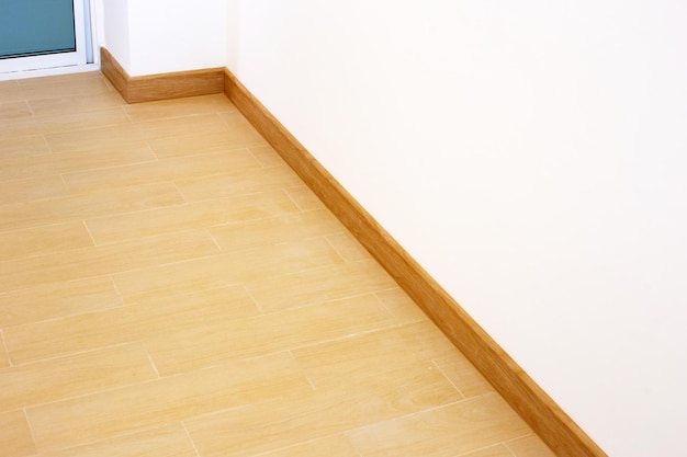 Wooden pattern tiles floor with blank white wall