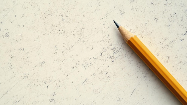 Photo wooden pencil with yellow paint on speckled background