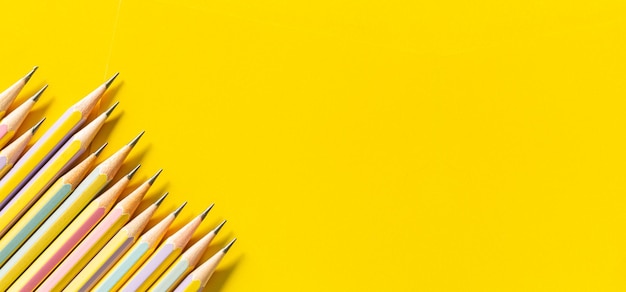 wooden pencil on yellow background,Templates with copy space by the macro image in the upper corner