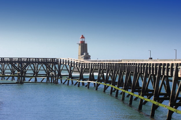 Wooden pier and  lighthouse of the port of fécamps in normandy france