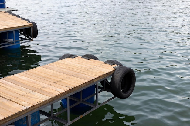 Wooden pier and old tires on the lake