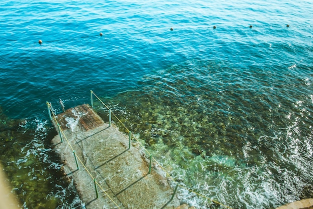 wooden pier in the sea with waves