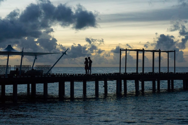 Wooden pier at sunset exotic tropical travel landscape