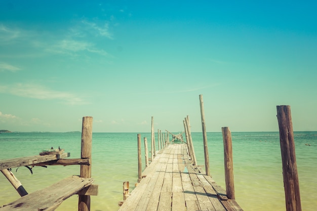 Wooden platform entering the turquoise sea on Koh Sameth island in Thailand.