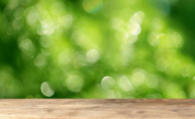 Wooden podium table with bokeh greenery background. The front showcase with a stage for products.