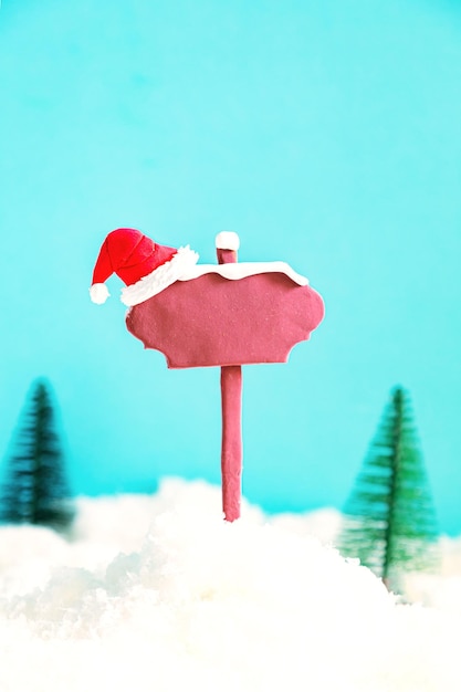 Wooden pointer and Santa's hat on a blue background