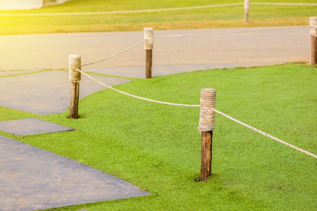 Wooden poles wrapped with rope use for Block grass field