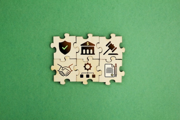 wooden puzzle with bank icons law policy procedure agreement regulations Concept of compliance