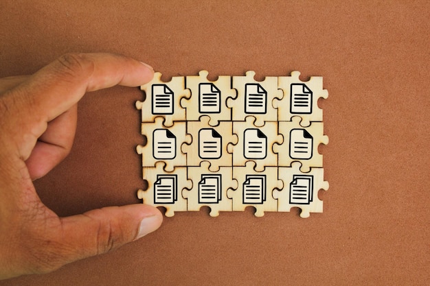 wooden puzzle with stacked file icons Concept document management system or DMS DMS Concept