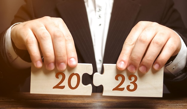 Wooden puzzles with the inscription 2023 Setting goals and objectives for the new year Planning business management and strategy concept Trends and ideas Vision