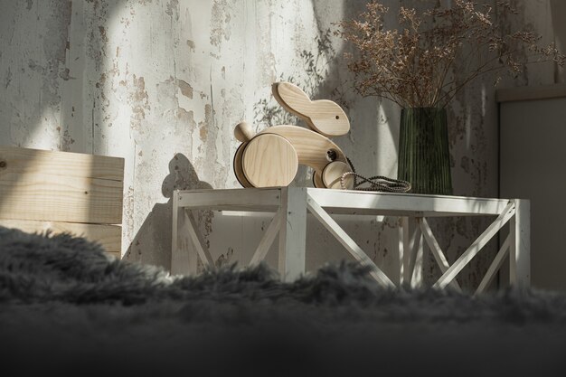 Wooden rabbit on wheels of beech on table