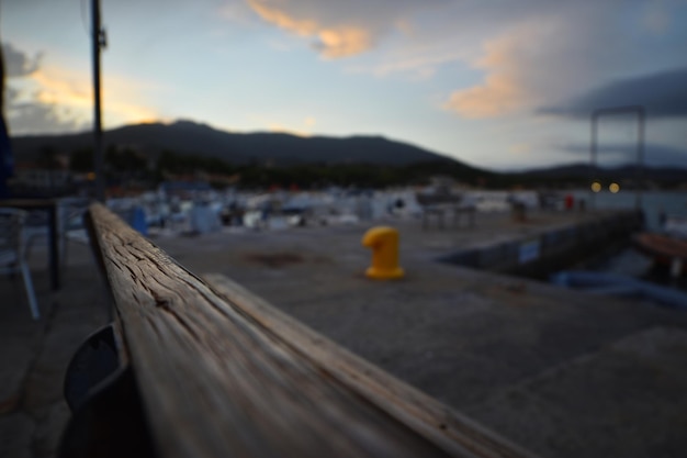 A wooden railing with a yellow object on it