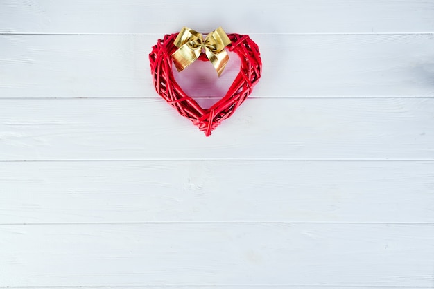 Wooden red heart  on white wooden background. Valentine's background