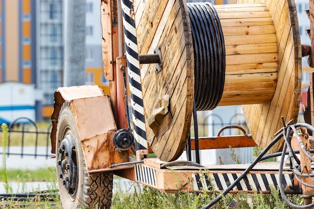 Wooden reel with high voltage cable mounted on a trailer for easy transport and stowage Laying a highvoltage power cable in the ground Laying of cables laying of underground communications