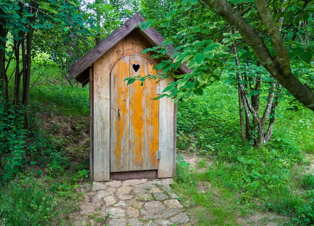 Wooden shed ecological composting toilet on countryside eco farm Concept image