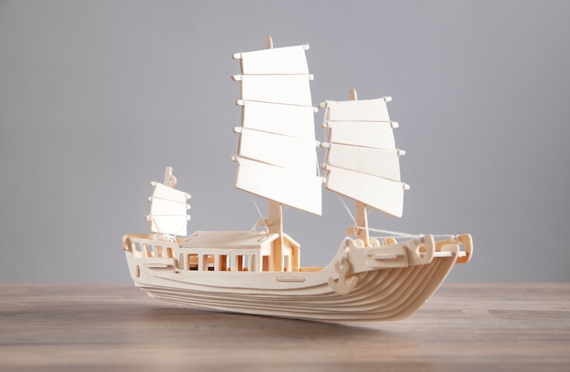 Wooden ship model on the desk. Travel and Adventure