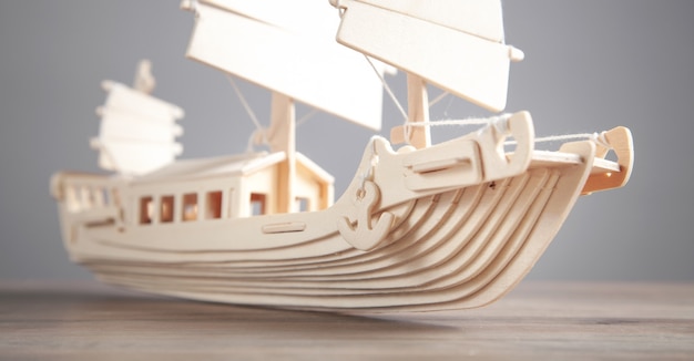 Wooden ship model on the desk. Travel and Adventure