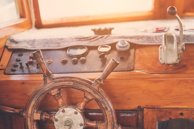 Wooden ship's helm and the control panel