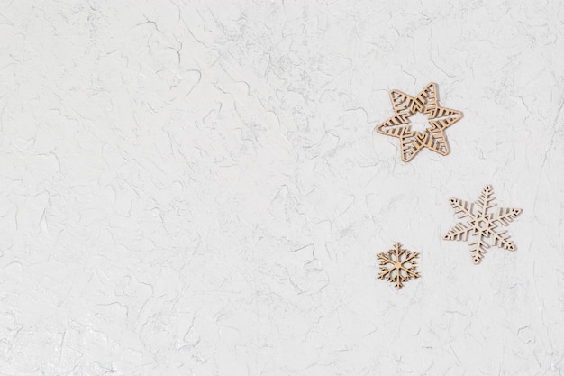 Wooden snowflakes on glitter background with copy space Concept for New Year or Christmas