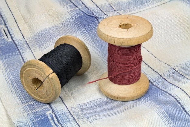 Wooden spools with threads on fabric