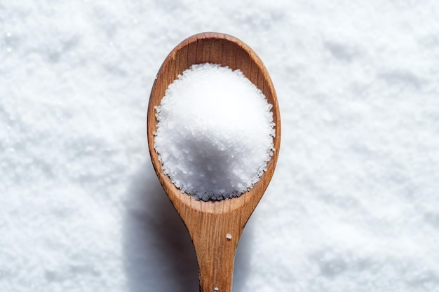 a wooden spoon filled with salt