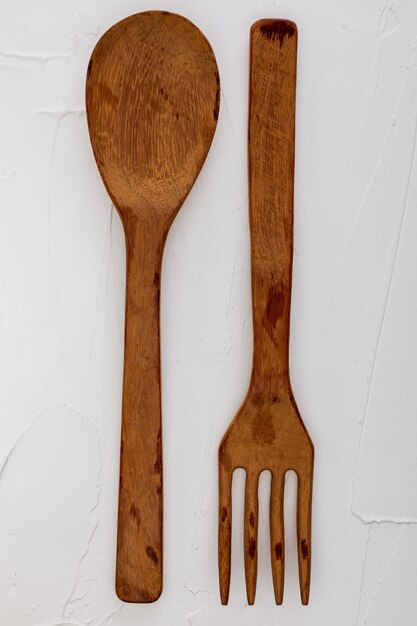 Wooden spoon and fork. Space to insert your text here. Letter for restaurants. (Food concept of spoon, pot).