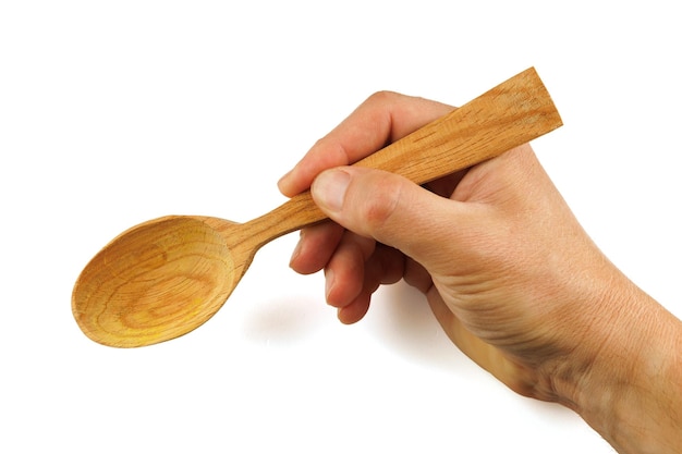 Wooden spoon in hand isolate