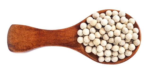 Wooden spoon and peppercorn on white background