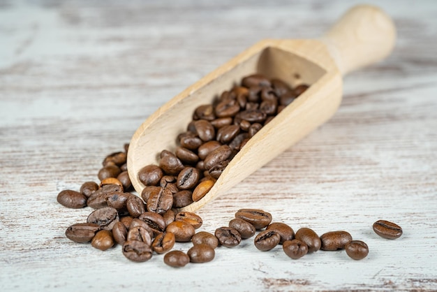 Wooden spoon with coffee beans ready to grind and enjoy their flavor