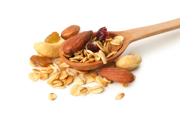 Wooden spoon with granola isolated on white background