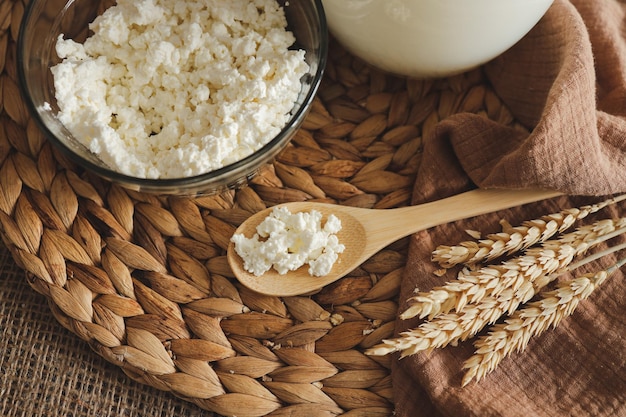 Wooden spoon with natural homemade cottage cheese milk and ears of corn