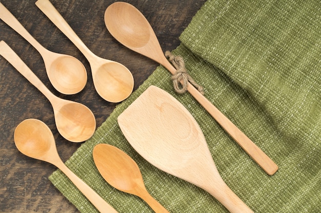 Wooden spoon and wooden ladle on a wooden table.tip view