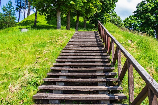 A Wooden Staircase Leads to the top of a High Mound.