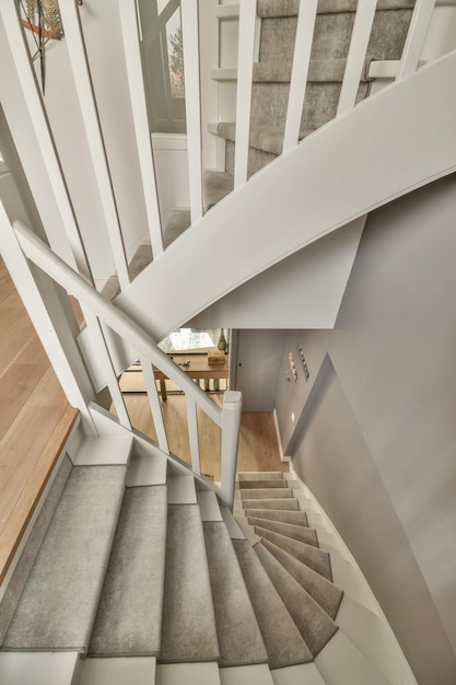 Wooden staircase in spacious hall of apartment